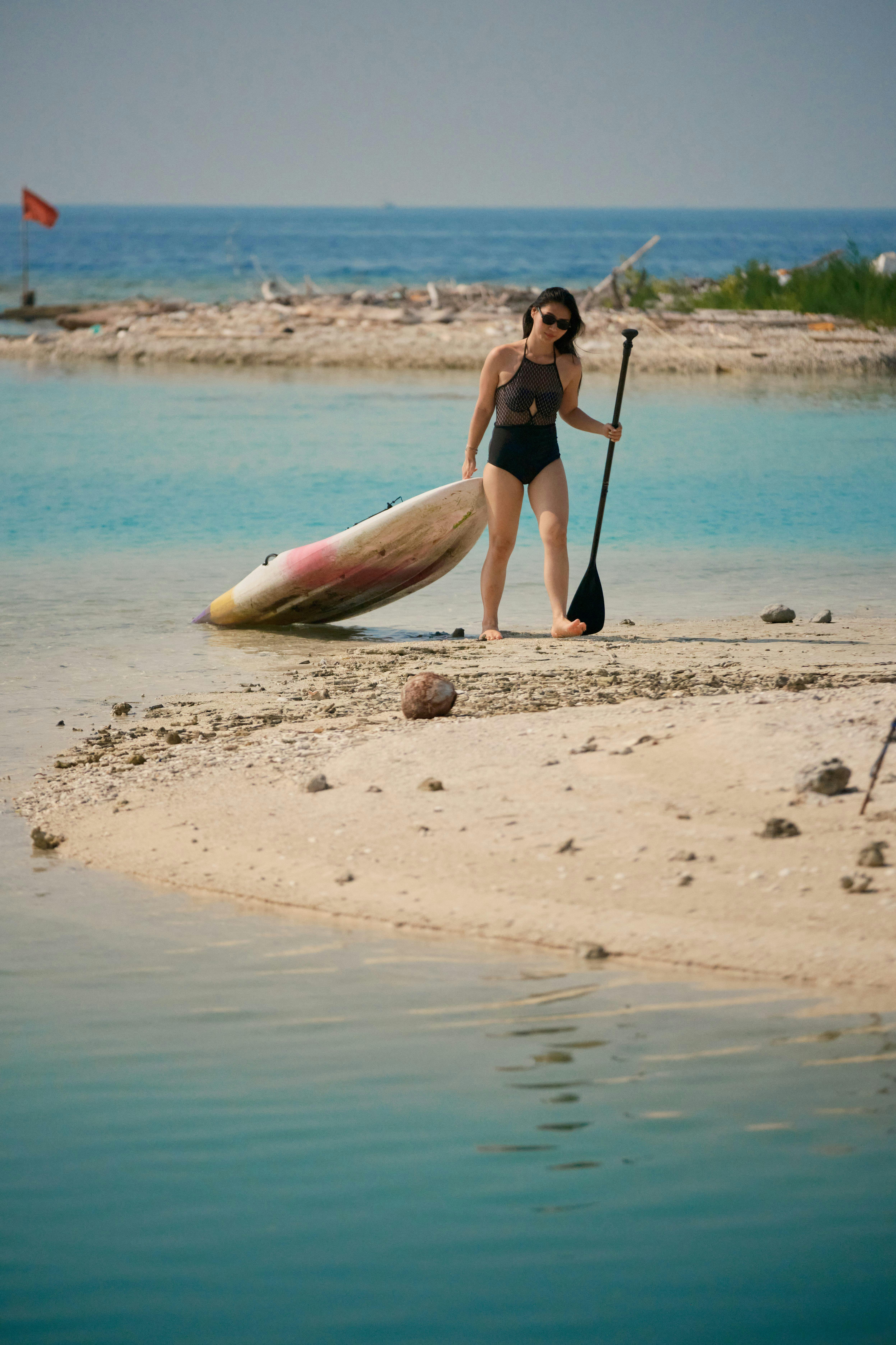 Girl paddle boarding with Batumera in Pulau Payung Lagoon in Thousand Islands