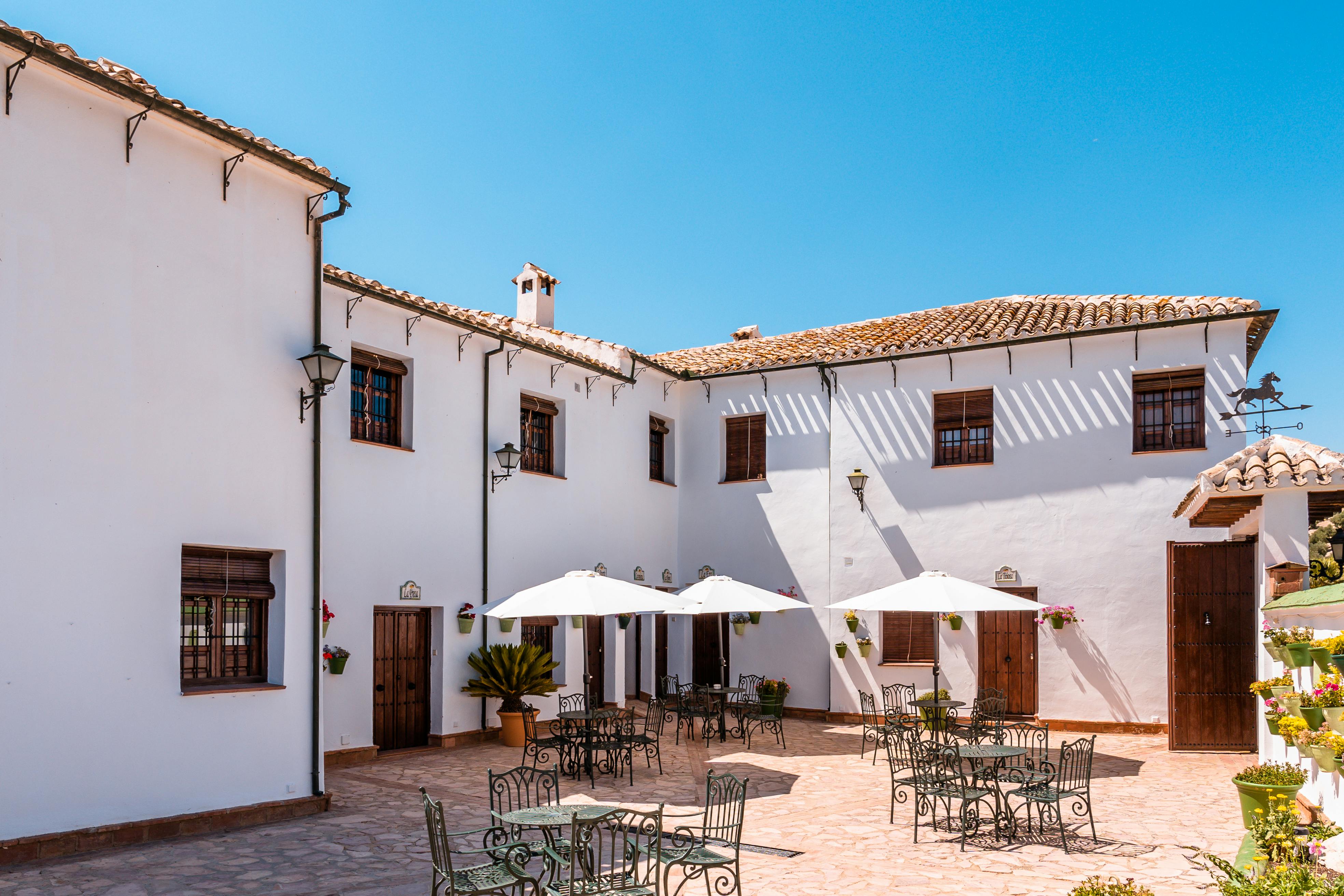 Courtyard patio with traditional tiled flooring, wooden beams, and rustic seating