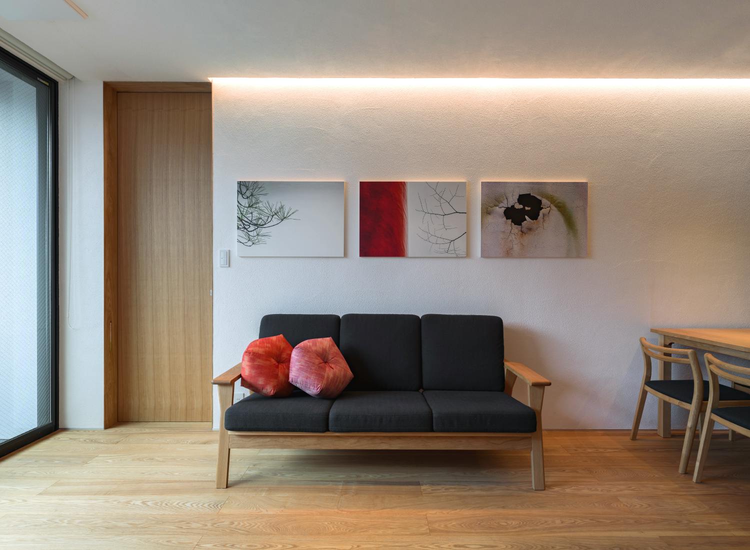 Kyoto Komatsu Residences - 2-room apartment living area featuring photos by John Einarsen and Ojami cushions by Takaokaya