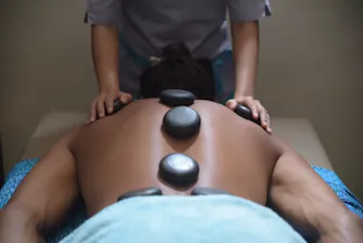 Hot stone massage treatment at Azure Wellness Spa in Gili Trawangan