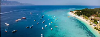 Aerial view of Gili Trawangan turquoise waters and tropical coastline