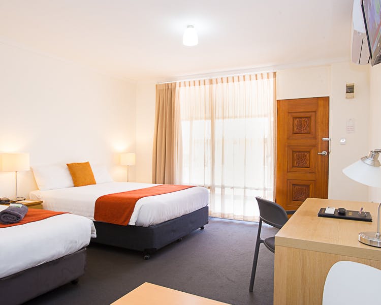 Clean, modern motel room with one double, one single bed.