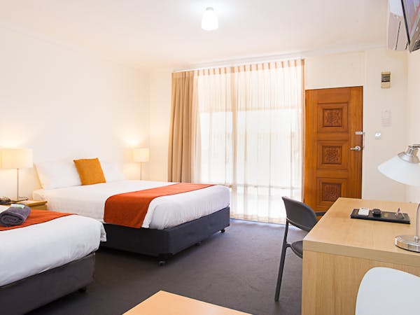 Clean, modern motel room with one double, one single bed.