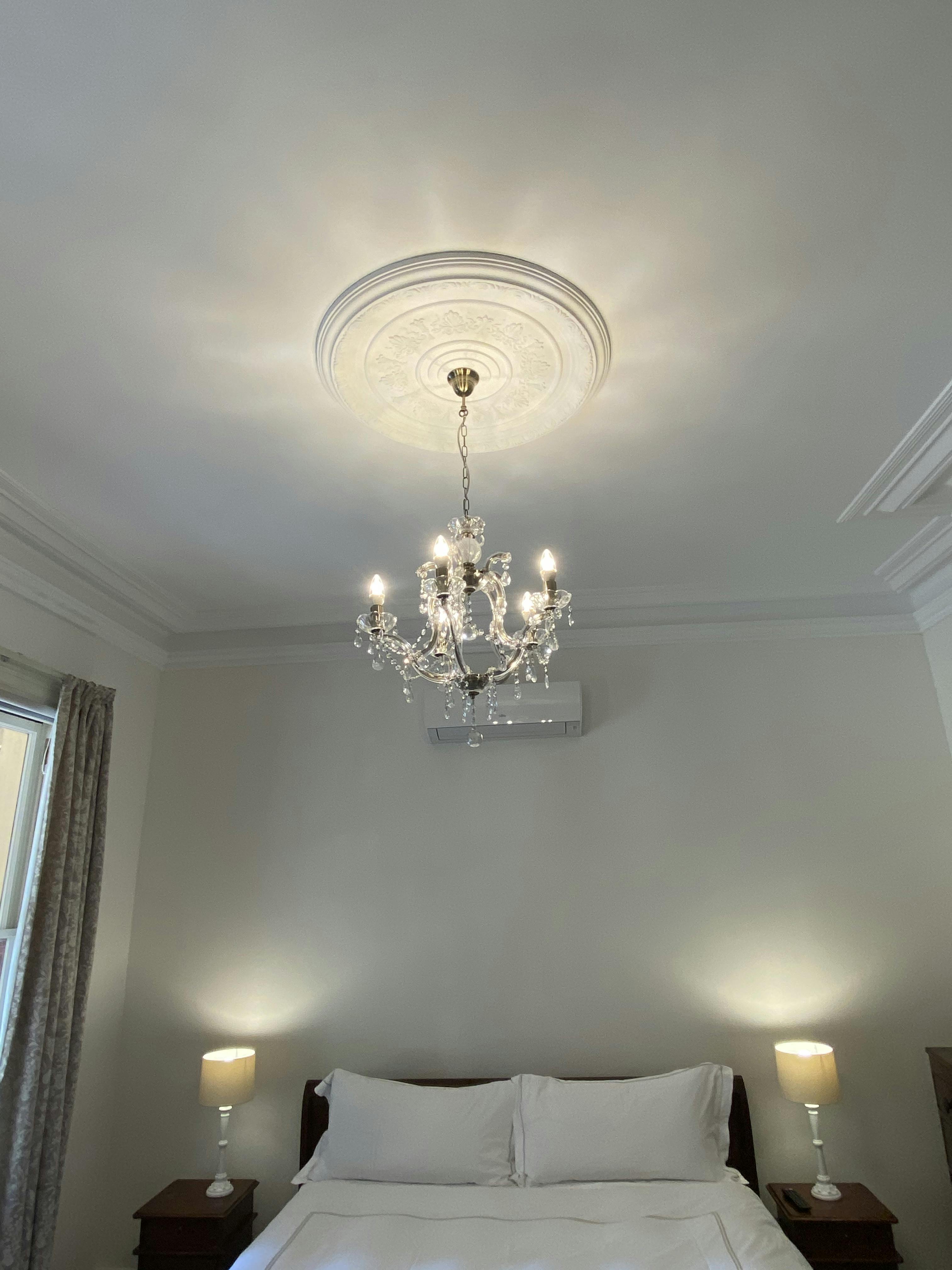 Homestead Room 1 with high ceilings and ornate moldings.