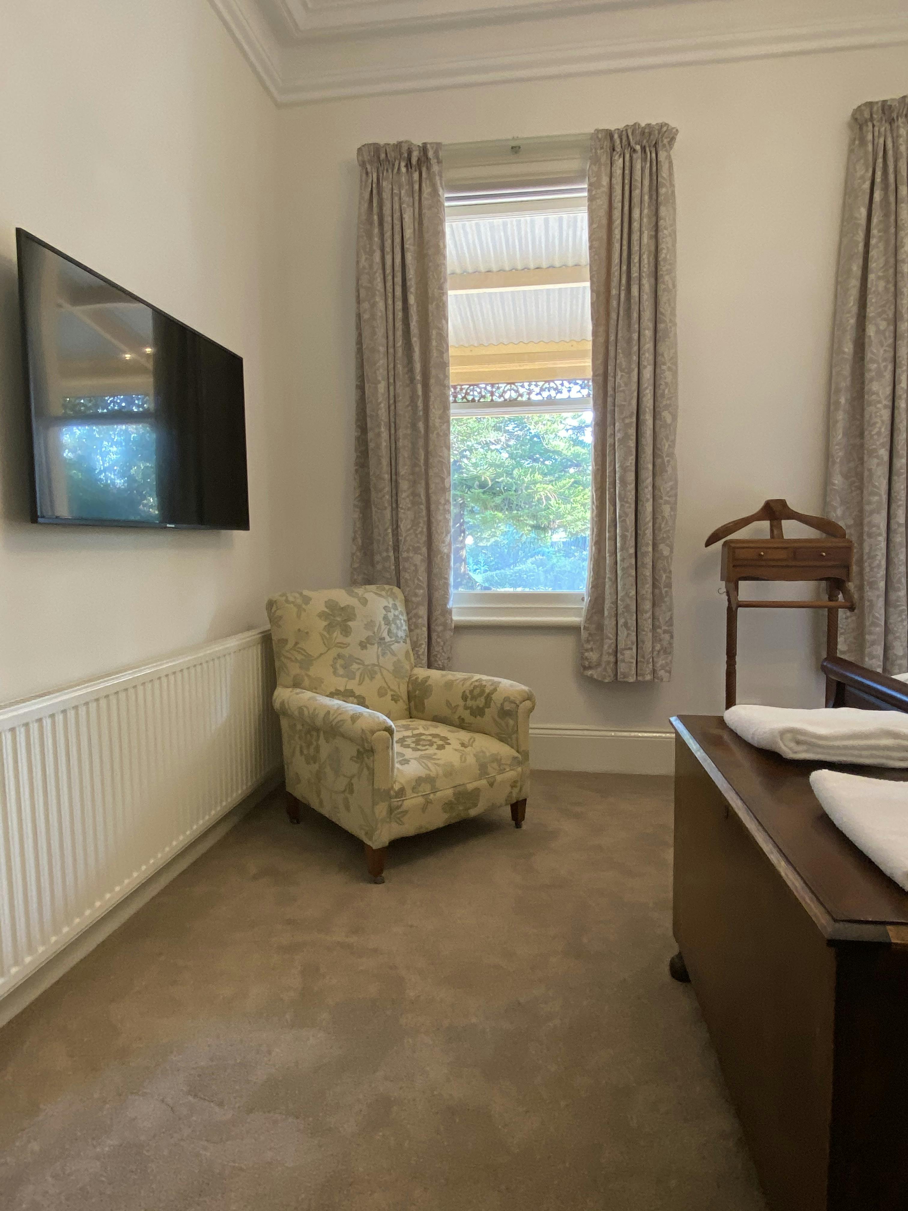 Homestead Room 1 with 50" TV, garden views.