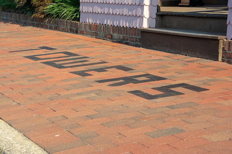 Brick sidewalk in front of Towers with the word "TOWERS" inlaid in the brick.