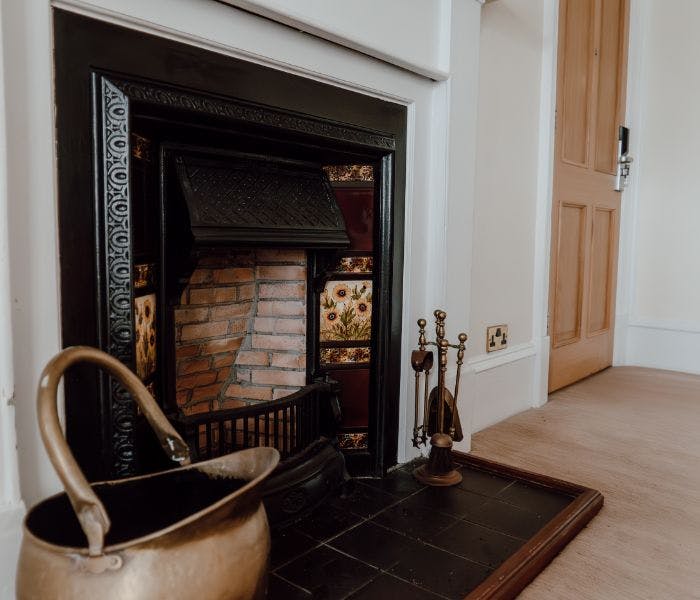 A traditional fireplace with a flat-screen TV hanging above, blending classic and contemporary elements in the decor.