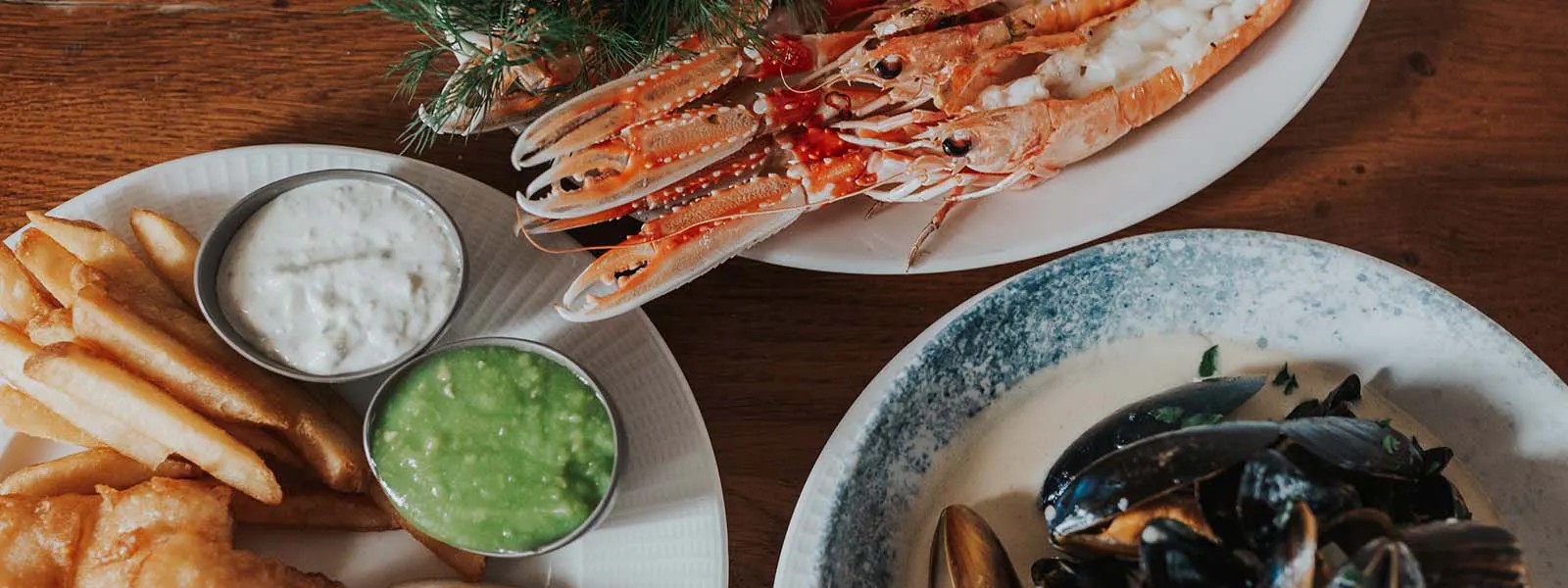 A vibrant table featuring a selection of seafood dishes at the Boatshed Restaurant within the Royal Hotel.