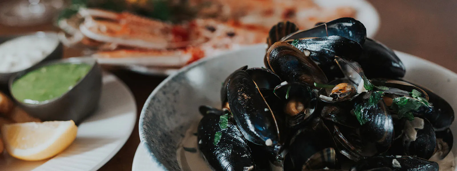 A vibrant table featuring a selection of seafood dishes at the Boatshed Restaurant within the Royal Hotel.