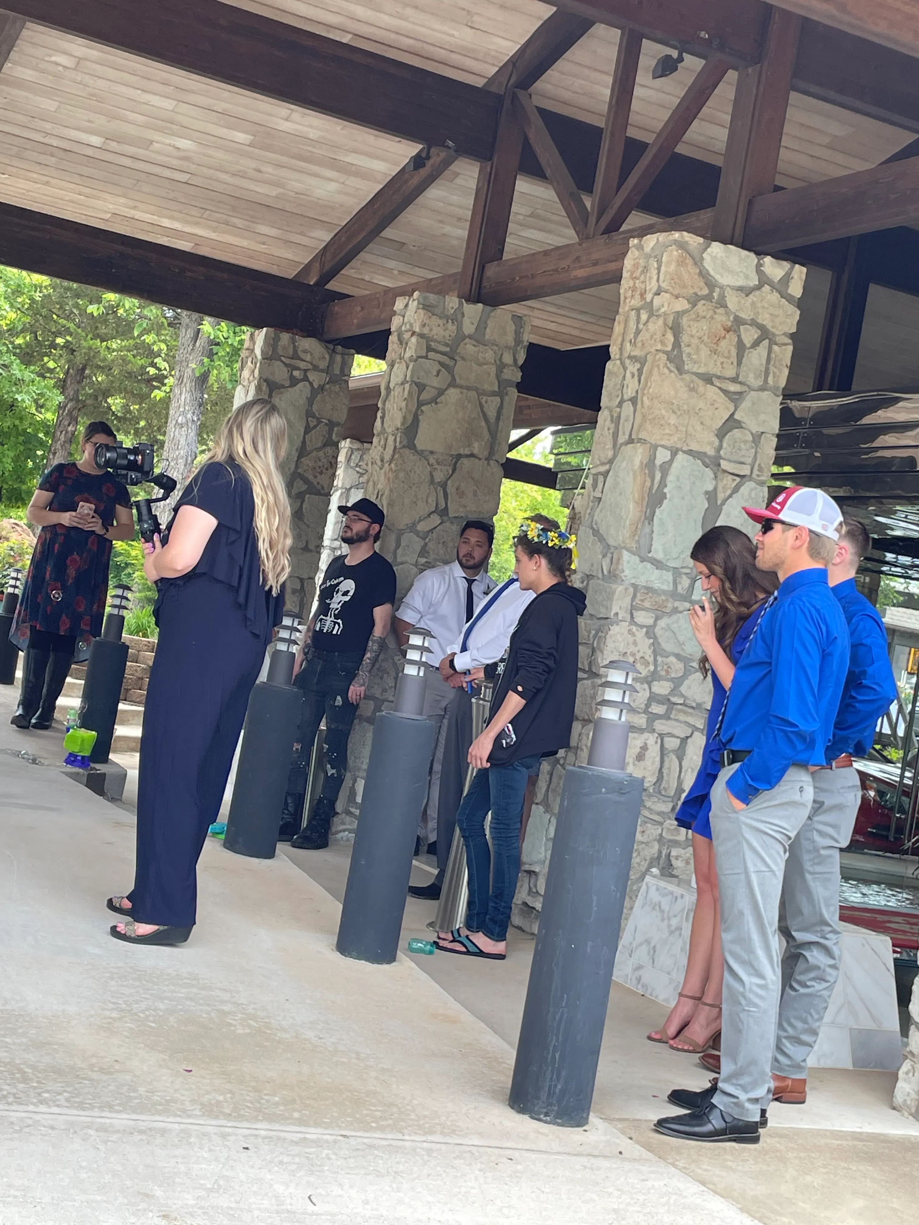Wedding party gathered under the covered stone entrance