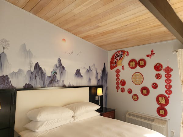 Romantic Chinese wedding-themed wall art in the Honeymoon Room at WangShi Palace — elegant and festive décor.