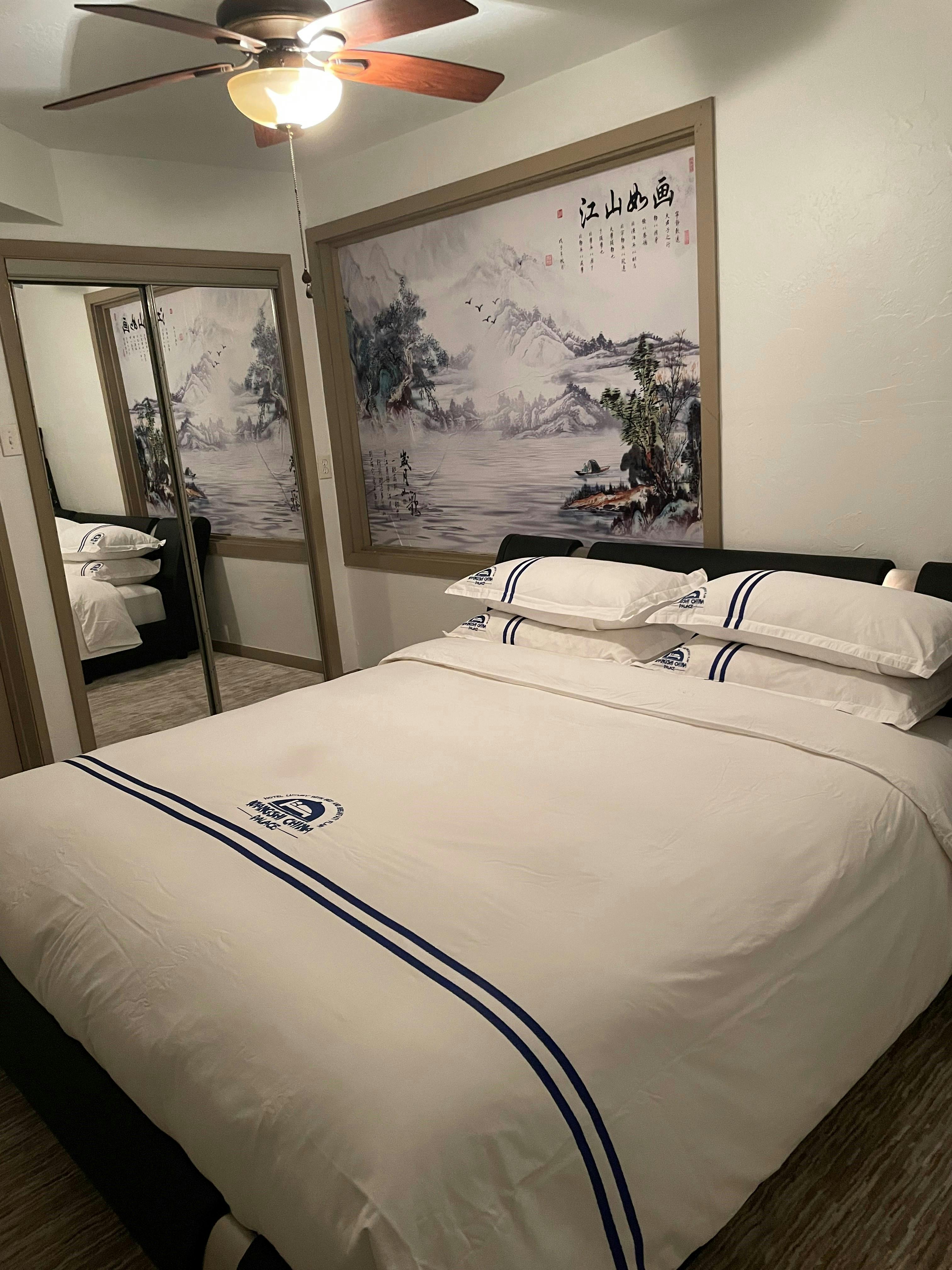 Standard Suite Type 11 master bedroom at WangShi Palace — comfortable king bed with Chinese landscape art