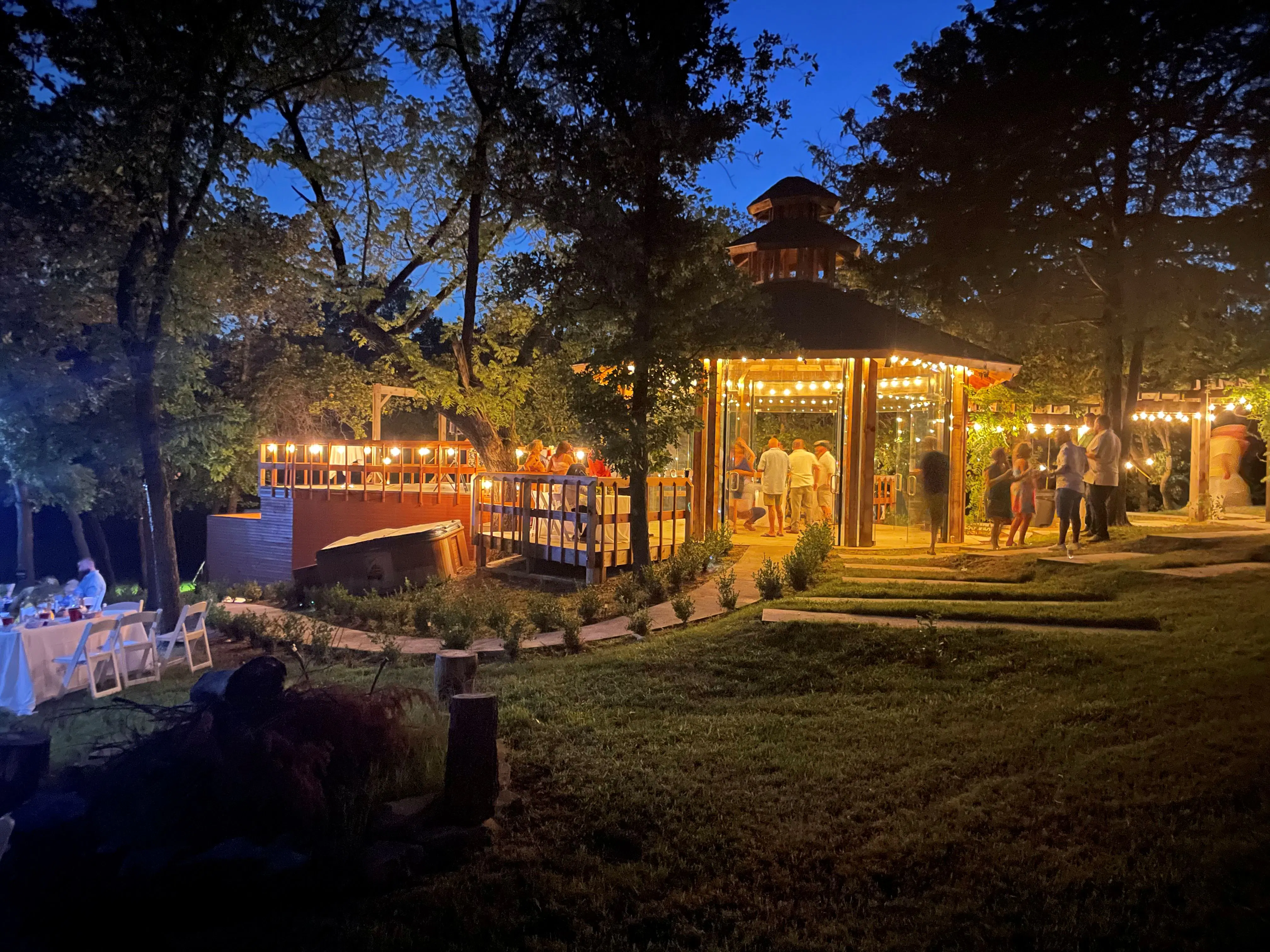 Evening event at the garden pavilion with string lights and guests