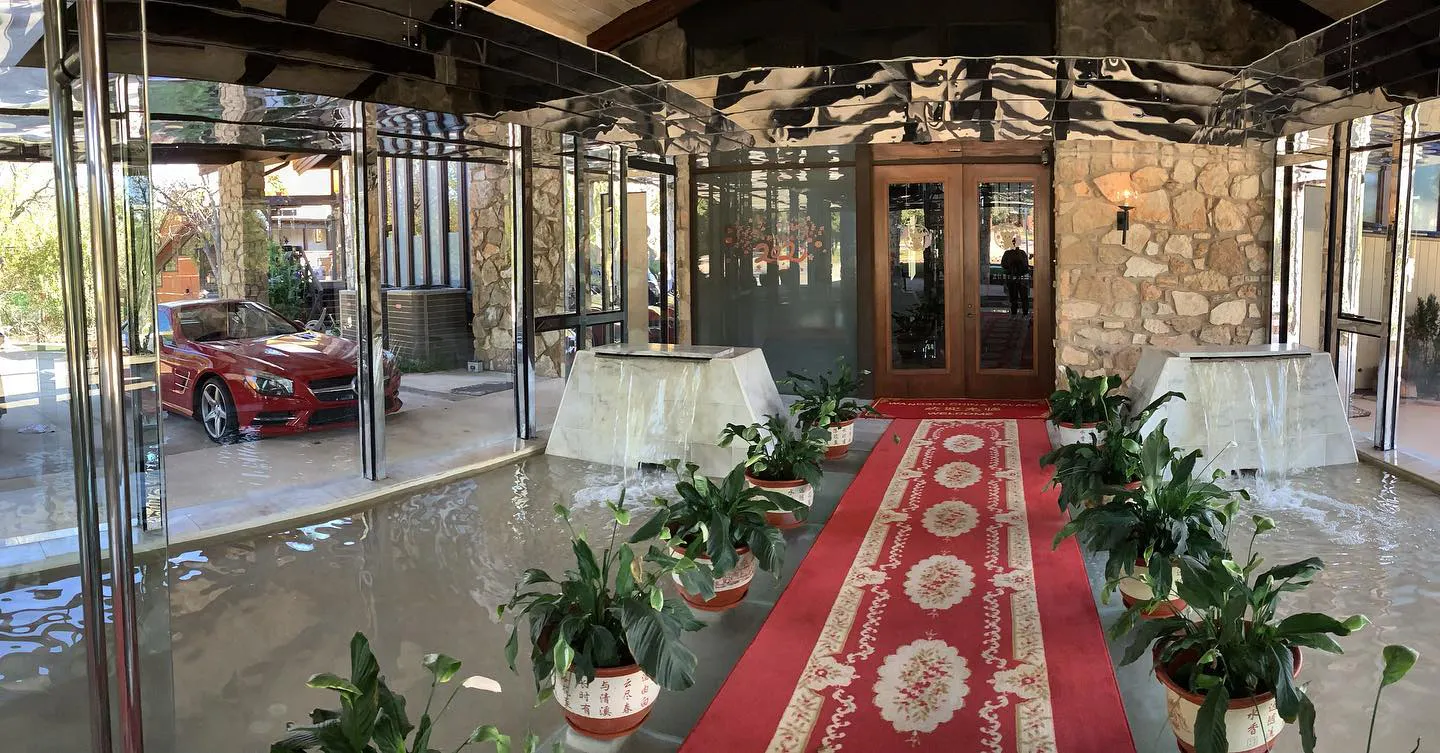 Entrance lobby of Wangshi China Palace with stone walls and red carpet