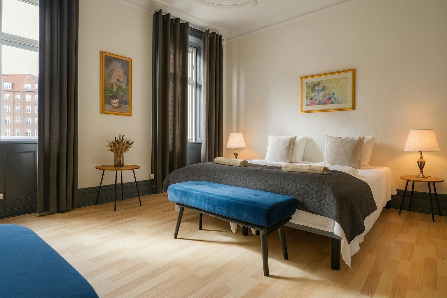 Spacious Hotel Amager Copenhagen junior suite with double bed and elegant blue bench