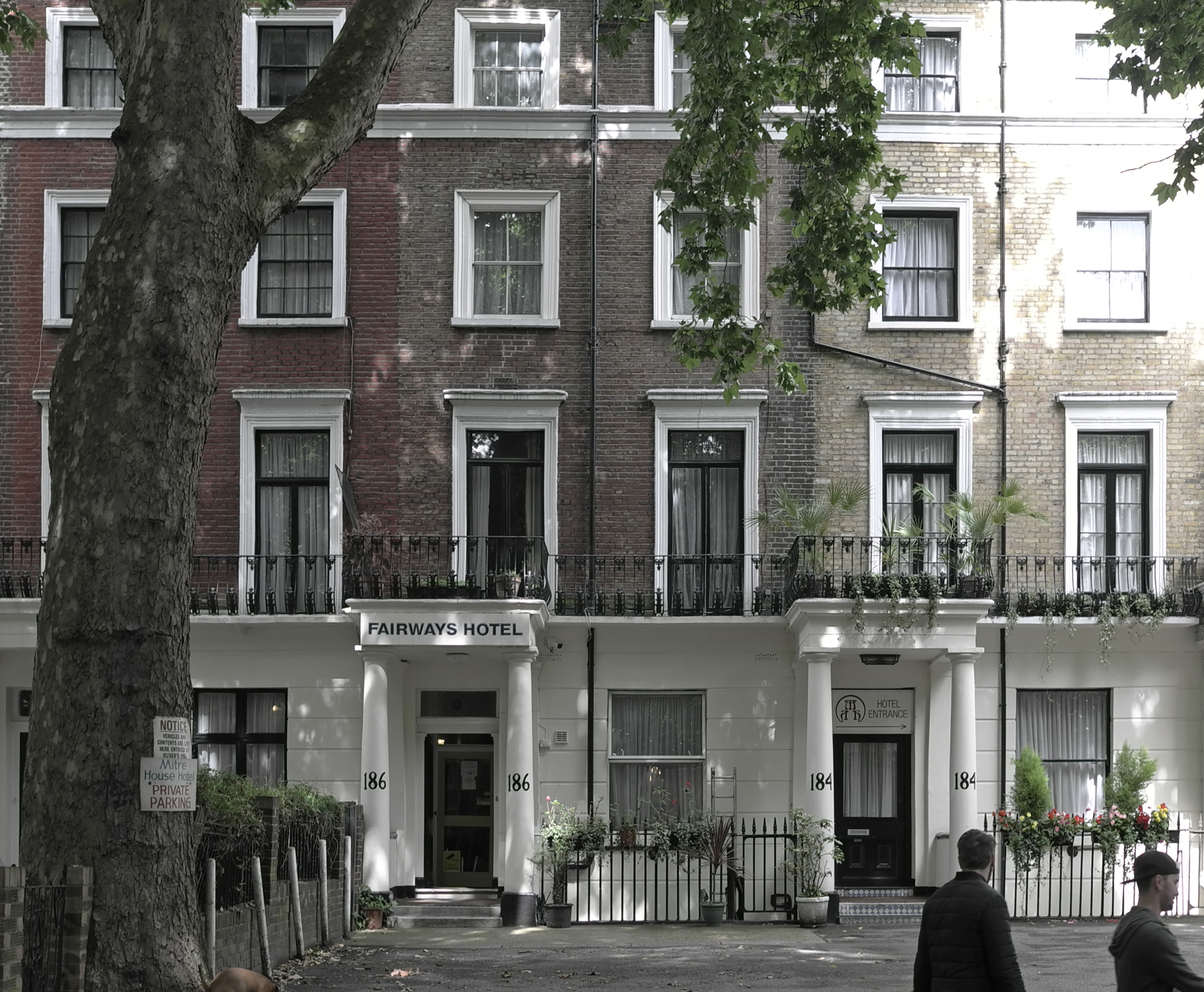 Front elevation of Fairways Hotel, Paddington. Tourists passing
