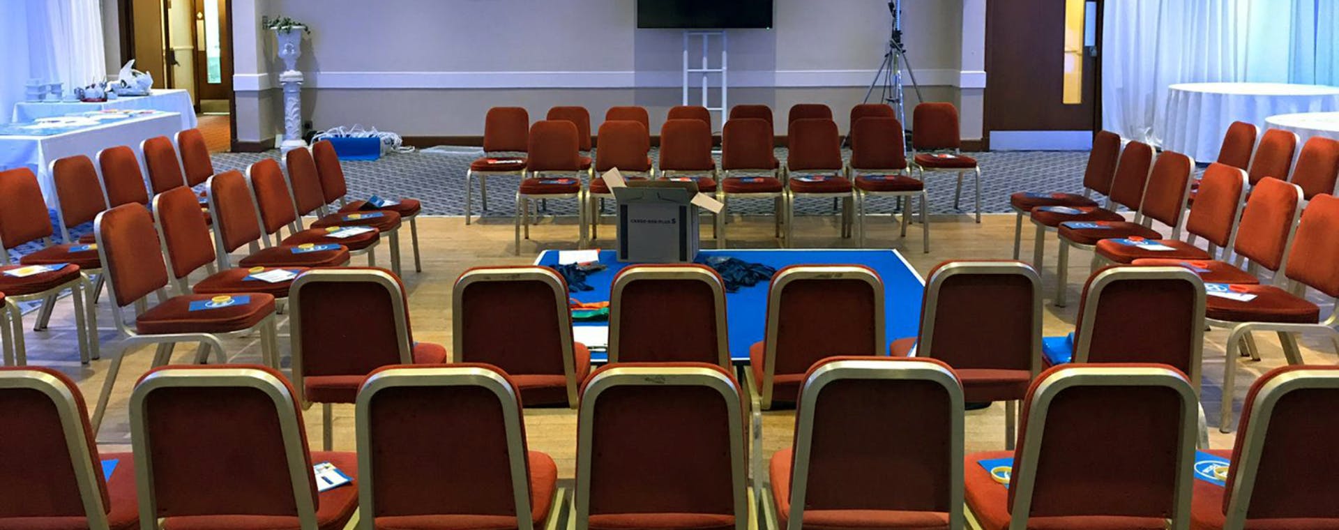 Caladh Inn Garry Room Meeting Setup, red chairs set around centre training area.