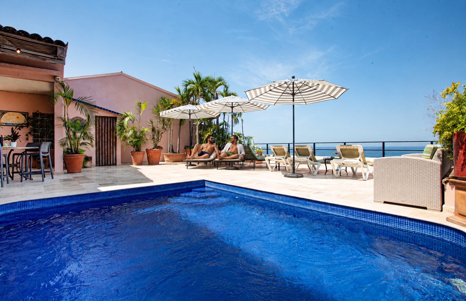 AI-created male couple relaxing at Quinta Maria Cortez