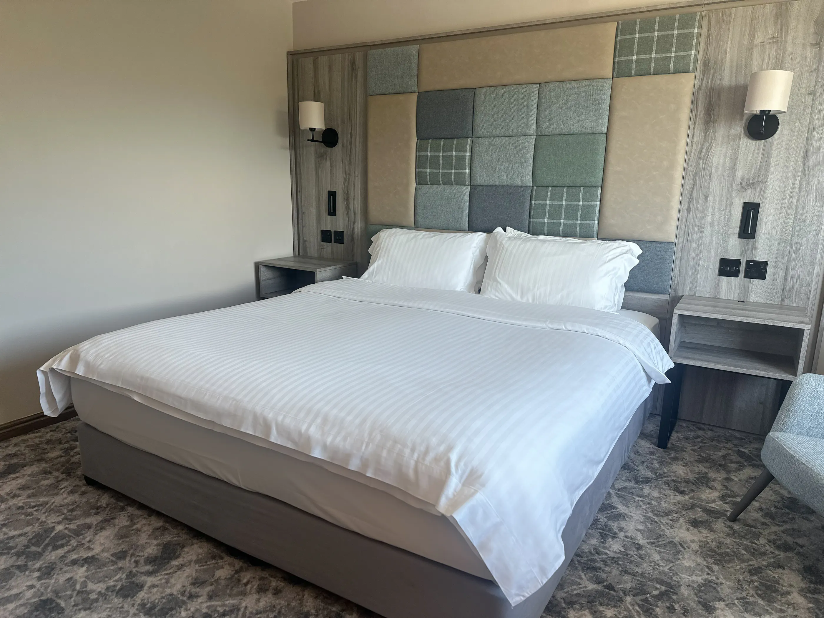 A welcoming light filled executive double room at Cabarfeidh Hotel with a comfortable bed.