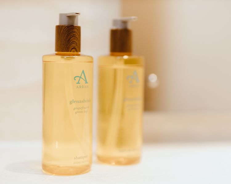 Bathroom closeup of hand soap and hand cream dispensers.