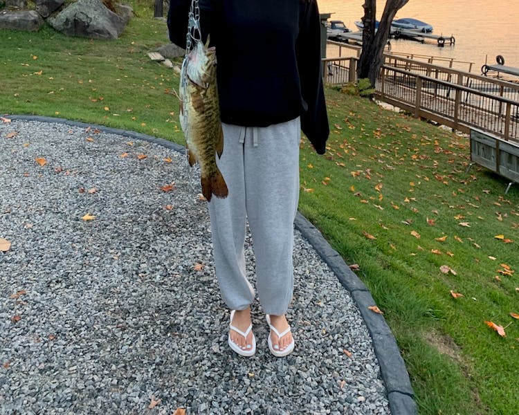 Kid-Friendly Fishing Cottages in Ontario - Girl Holding a Fish at DaySpring Cottages