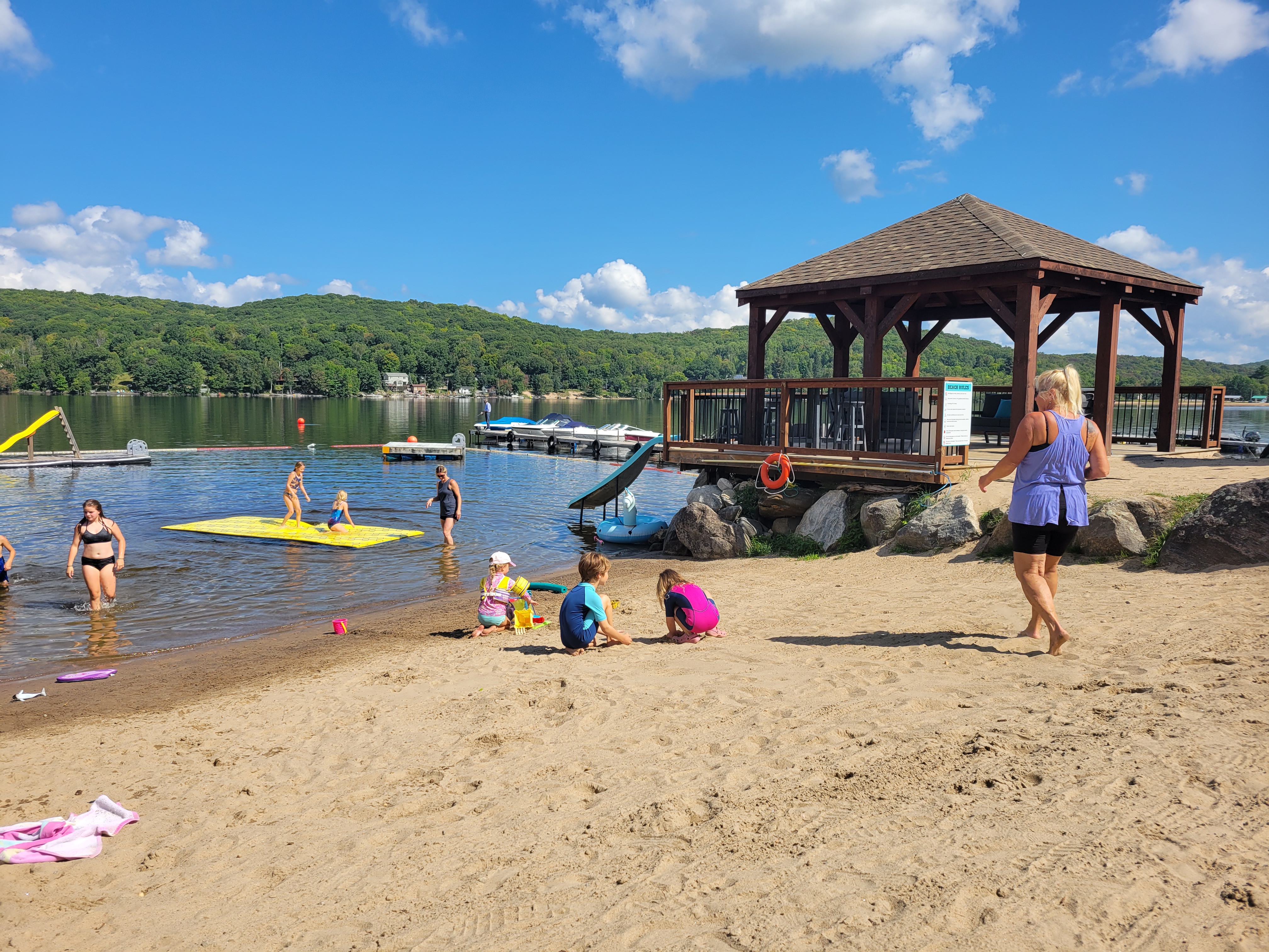 Family at the beach on doe lake.Kid-Friendly Beach Play at Dayspring Cottages - Little Girls Enjoying Sand and Sun