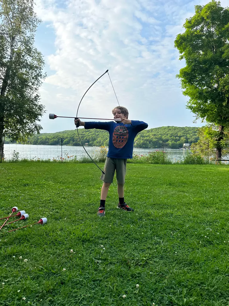 Kid-Friendly Activities at Dayspring Cottages - Young Archer Enjoying Bow and Arrow Fun