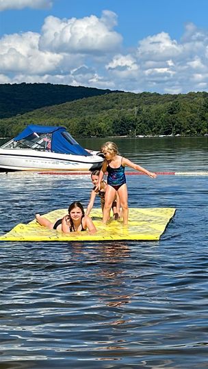 Sisters Having Fun on a Lily Pad at Dayspring Cottages - Kid-Friendly Water Play