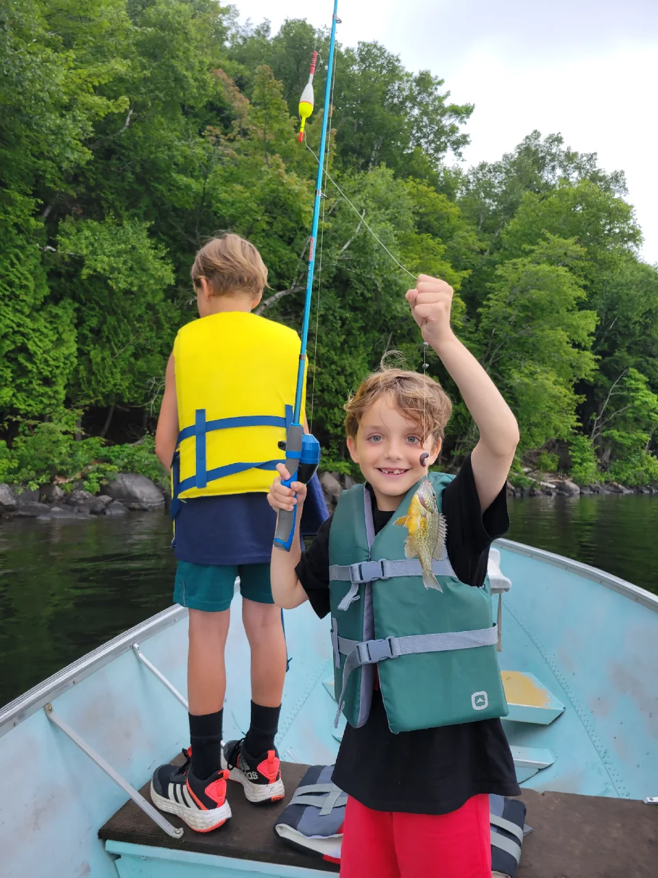 Kid-Friendly Fishing Cottages in Ontario - boy Holding a Fish at DaySpring Cottages