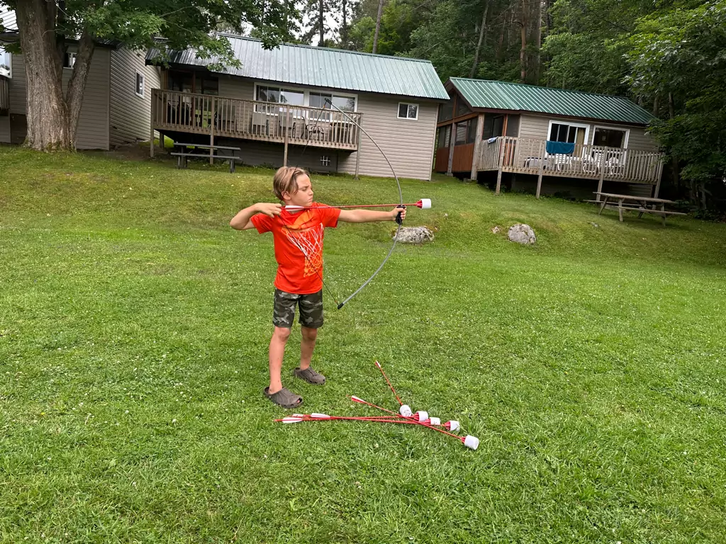 Kid-Friendly Activities at Dayspring Cottages - Young Archer Enjoying Bow and Arrow Fun