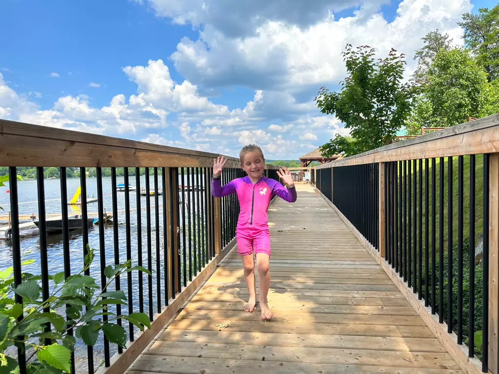 Kid-Friendly Boardwalk at Dayspring Cottages - Little Girl Enjoying Waterfront Scenic View"