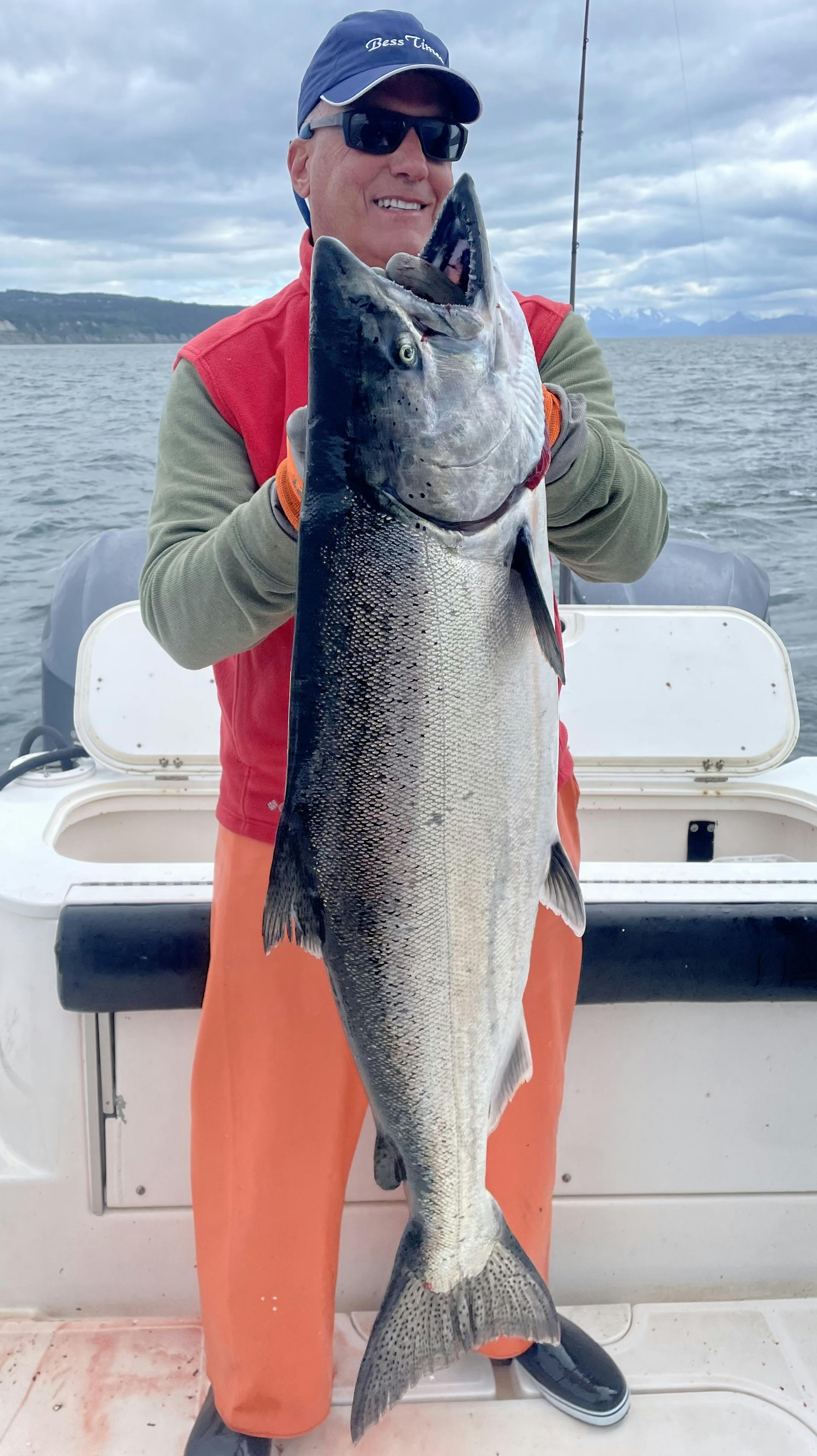 Fisherman posing with a king salmon he caught while on a saltwater fishing trip with Deep Creek Fishing Club, Alaska