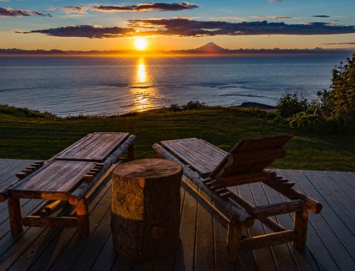 Sunset view of Mt Redoubt from the deck of one of he guest cabins