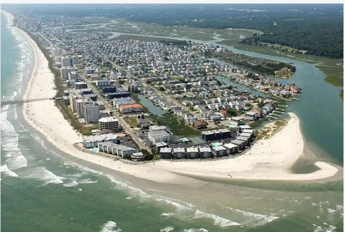 Aerial view of a beach town with buildings and ocean