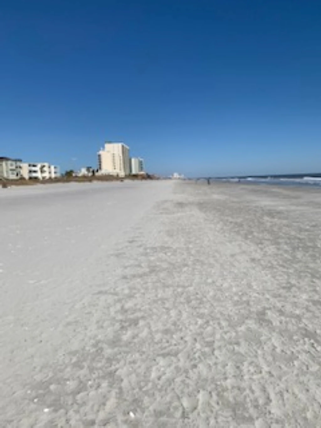 a beach with buildings in the background