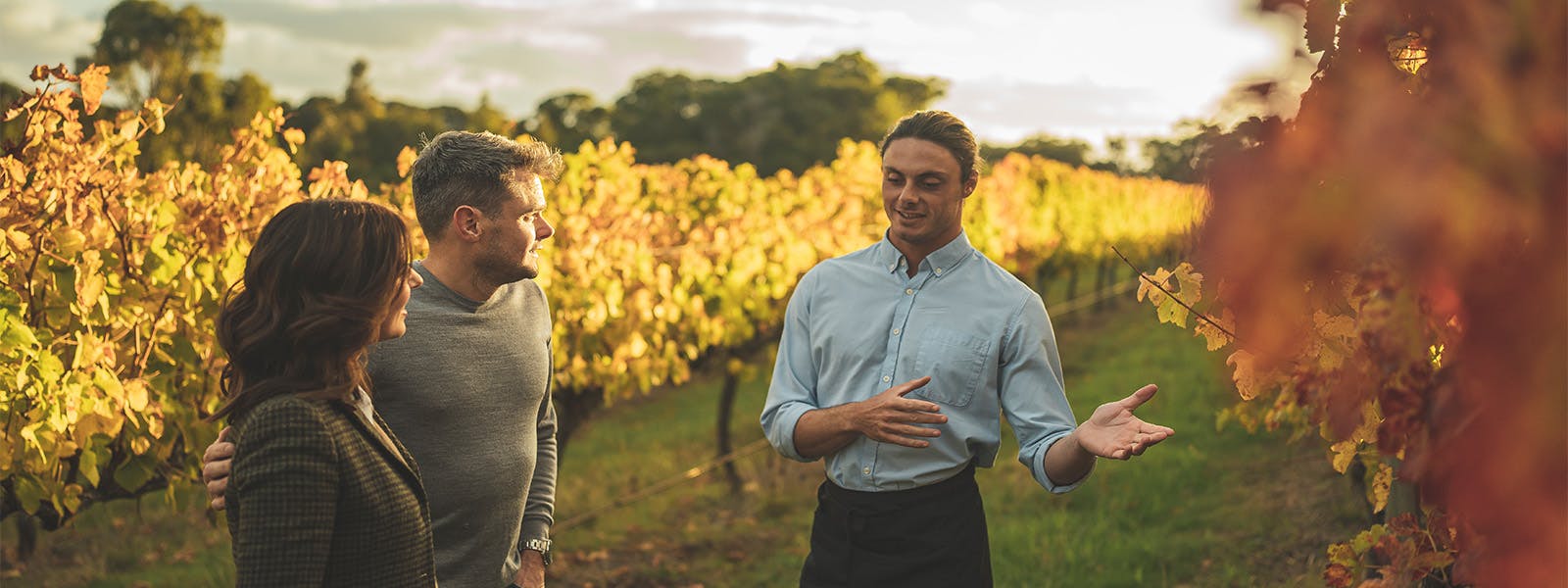 A guest and the Cape Lodge sommelier talking in the vineyards