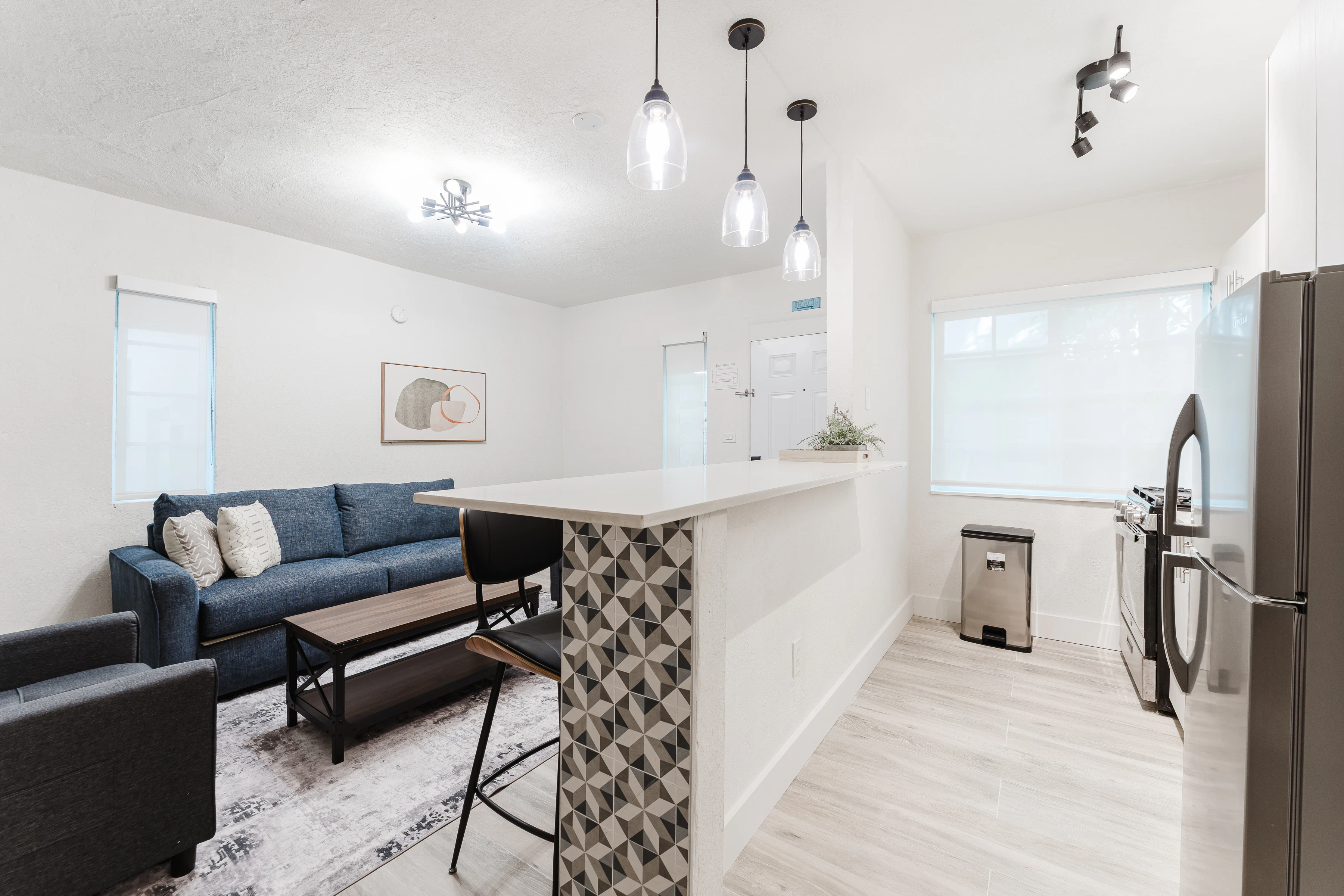A bright and modern living room with kitchenette