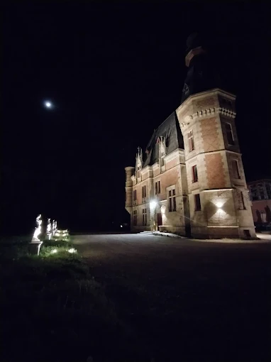 Façade historique illuminée Château de Petit-Bois Cosne-d'Allier, architecture XIXe siècle mise en valeur la nuit