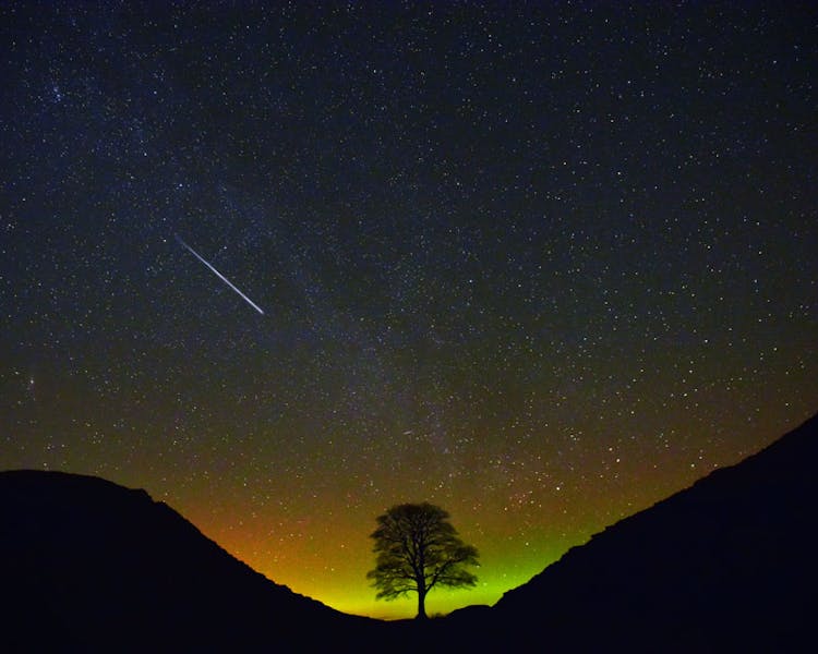 Sycamore Gap with night-time sky and comet.
