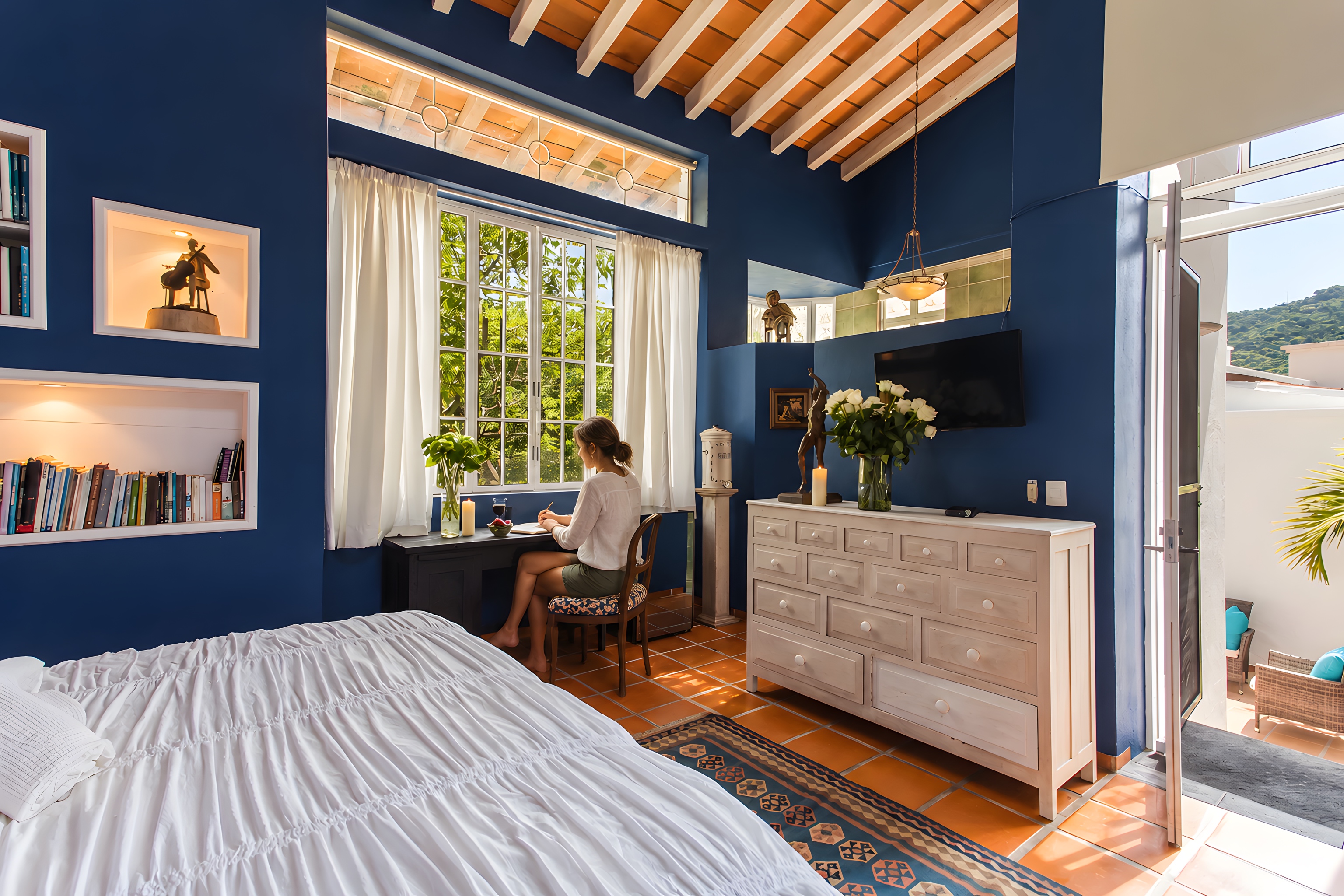 Guest writing by the window in a Garlands del Rio room