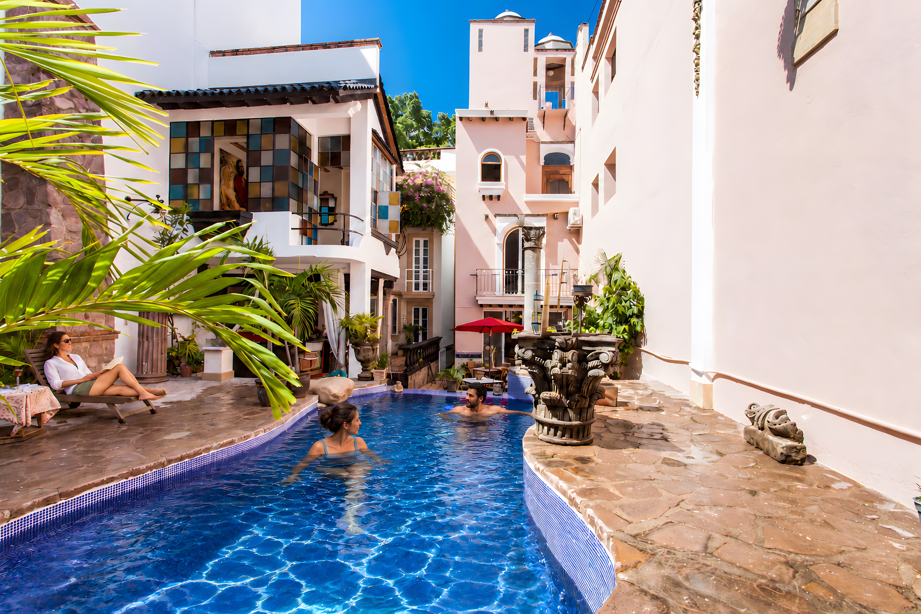 Guests swimming in the Garlands del Rio courtyard pool