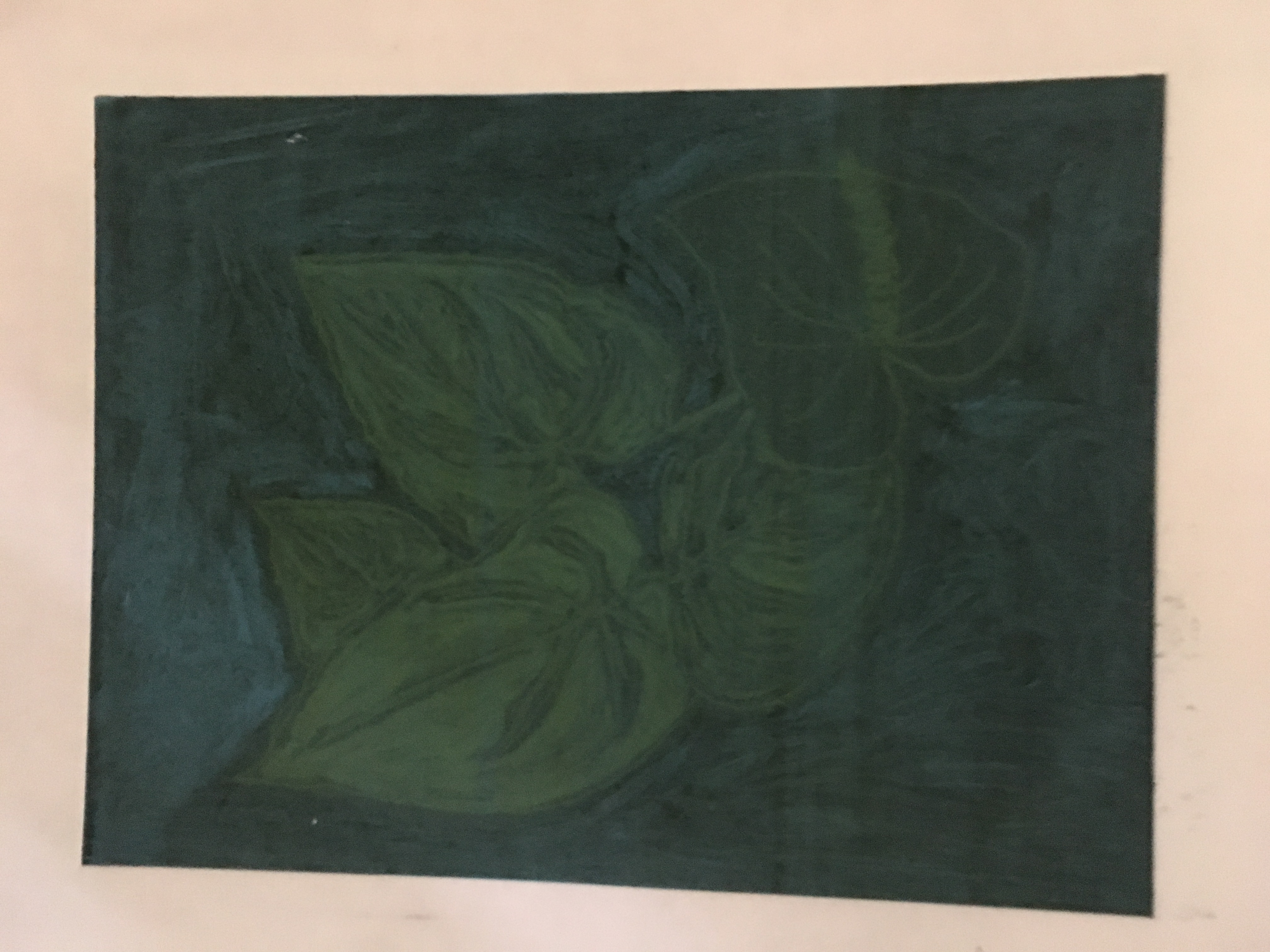 Print of plant leaves, in dark green ink.