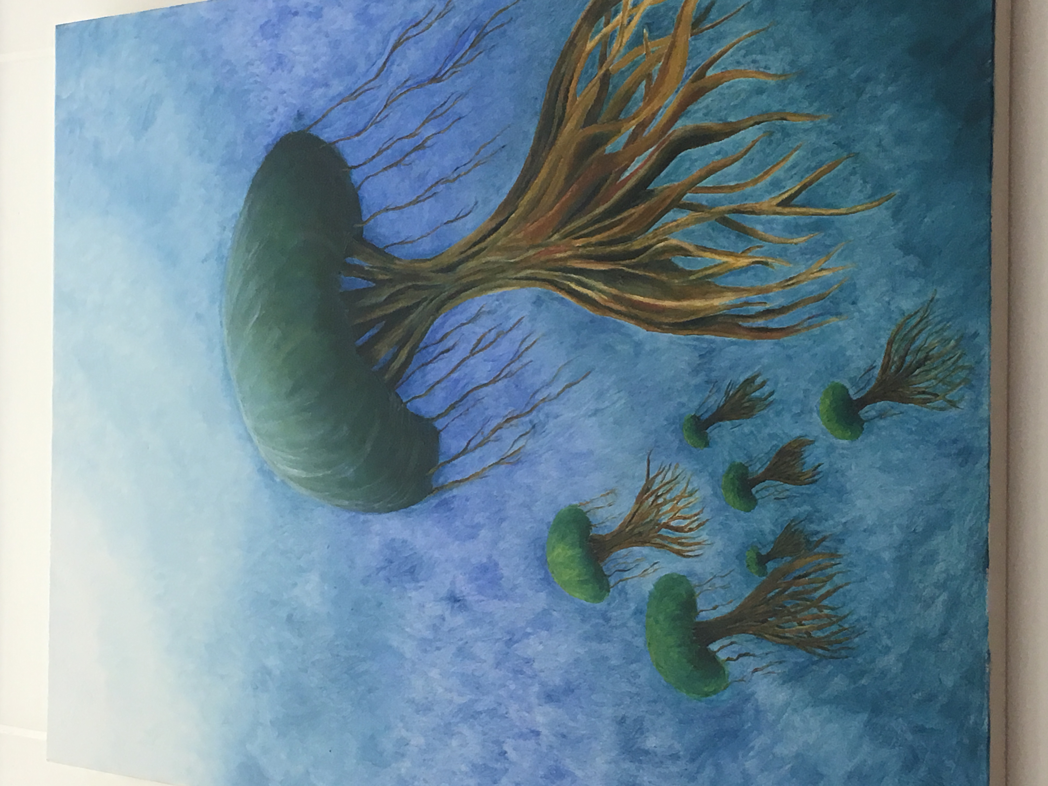 Detail of a painting in blues, greens and browns of imaginary trees emerging from water.