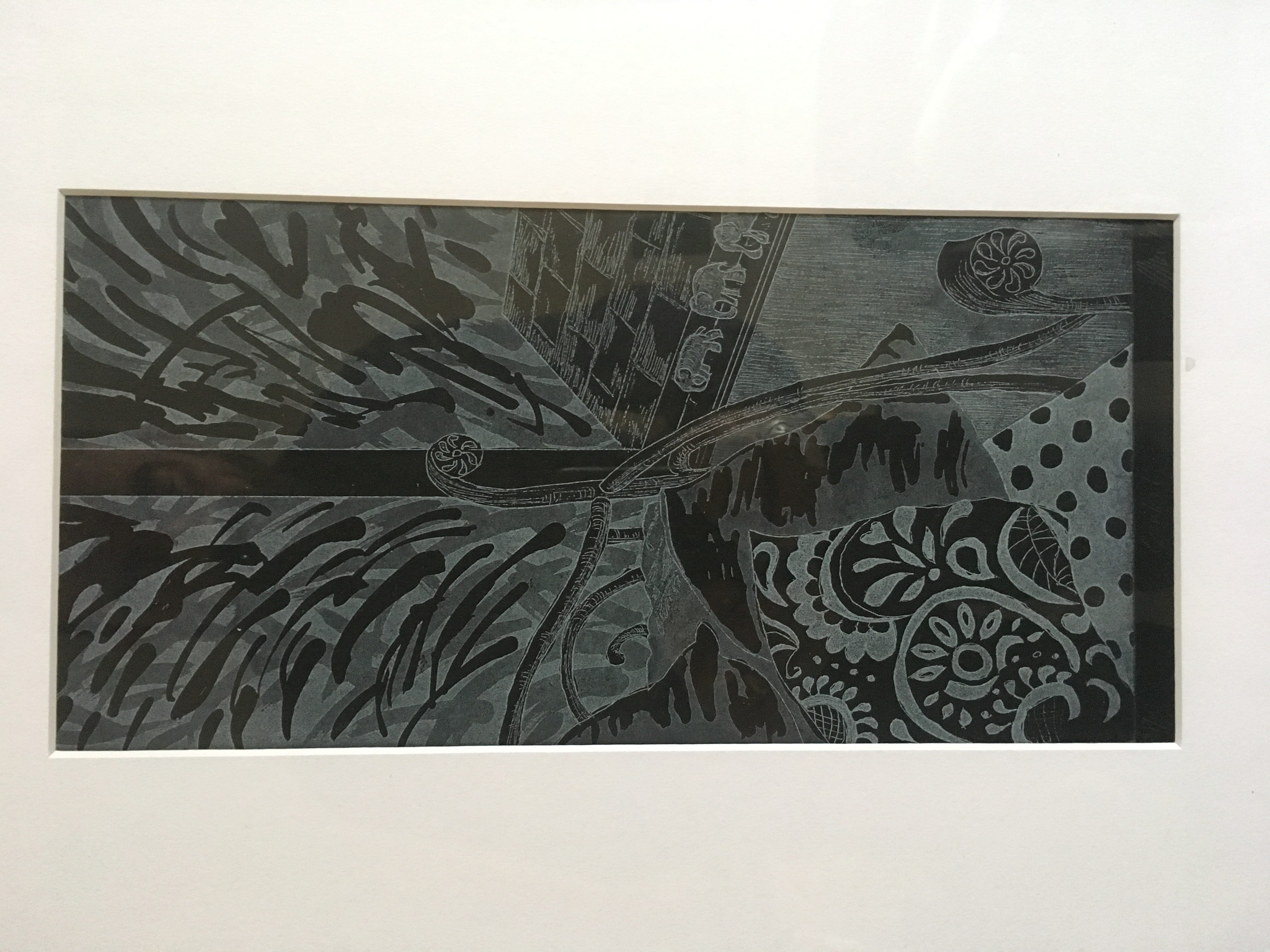 Detail of a print work showing cushions on a chair beside a window which looks out onto a garden.