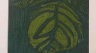 Print of plant leaves, in dark green ink.