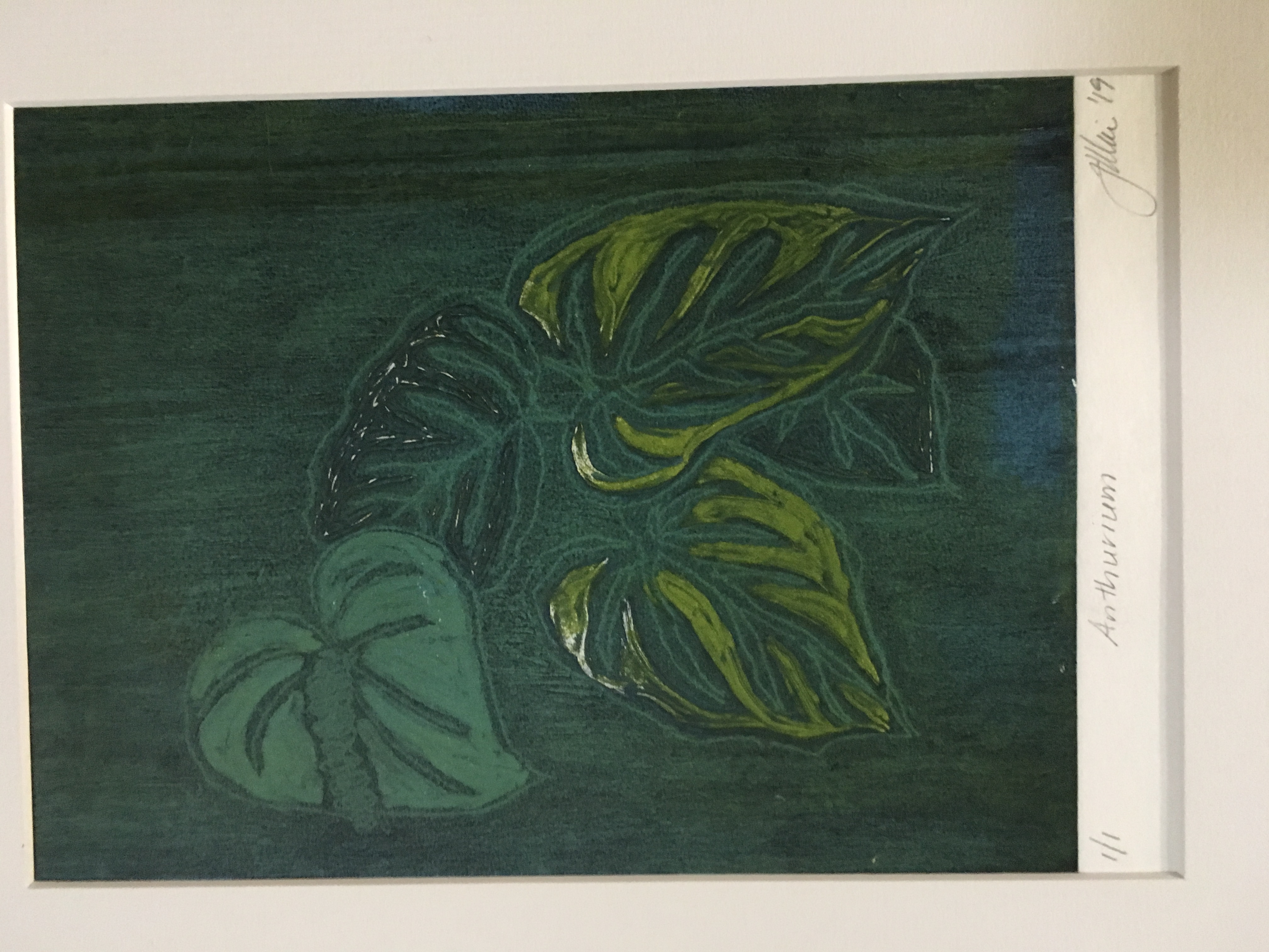 Print of plant leaves, in dark green ink.