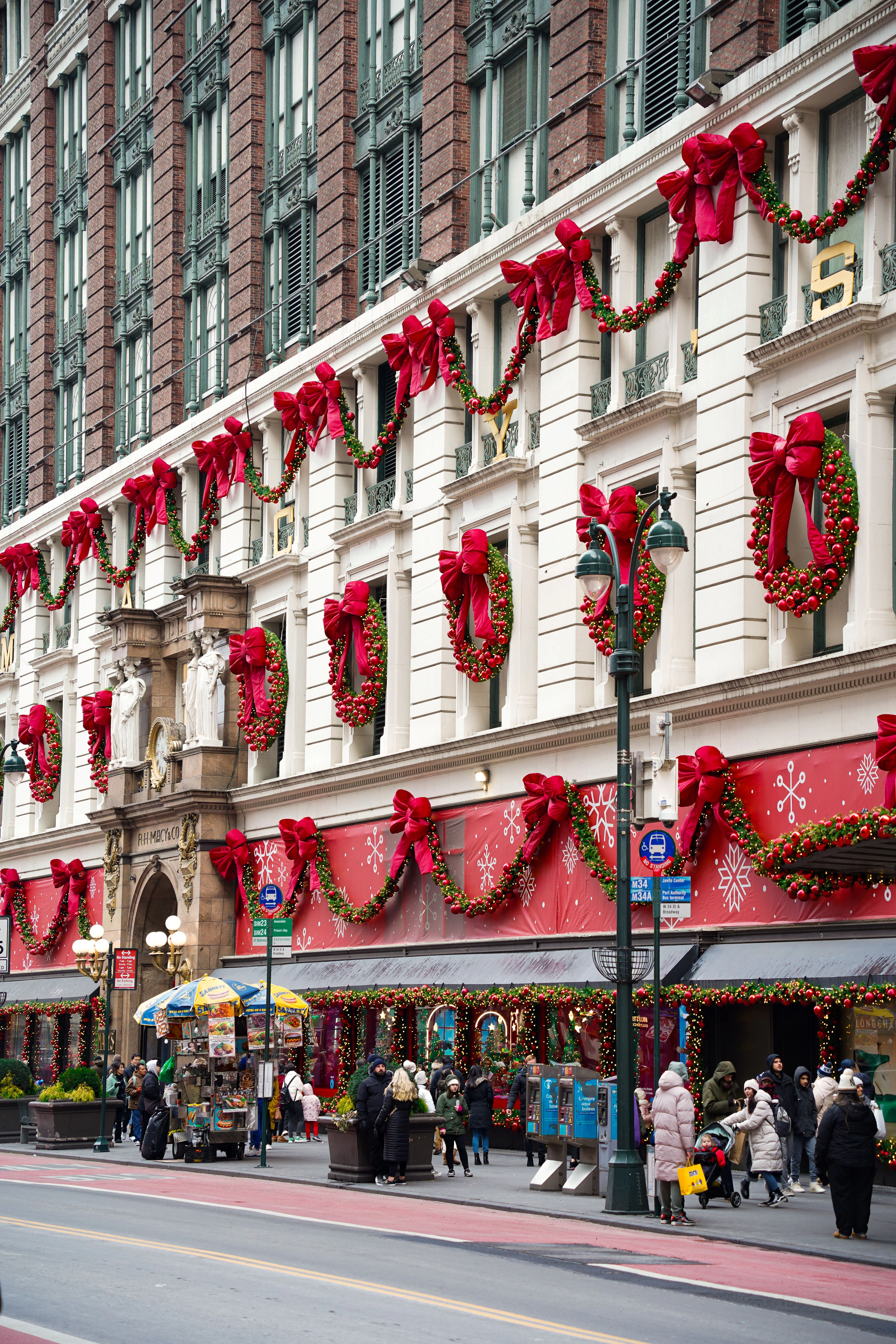 A large building decorated with Christmas garland and bows