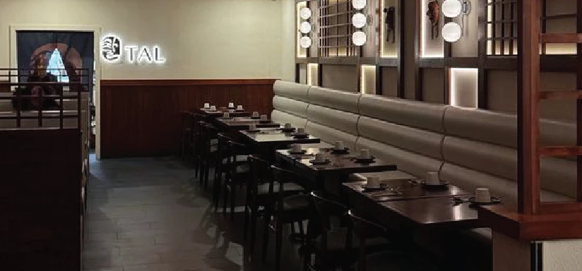 A restaurant dining area with booths and tables set for dining.