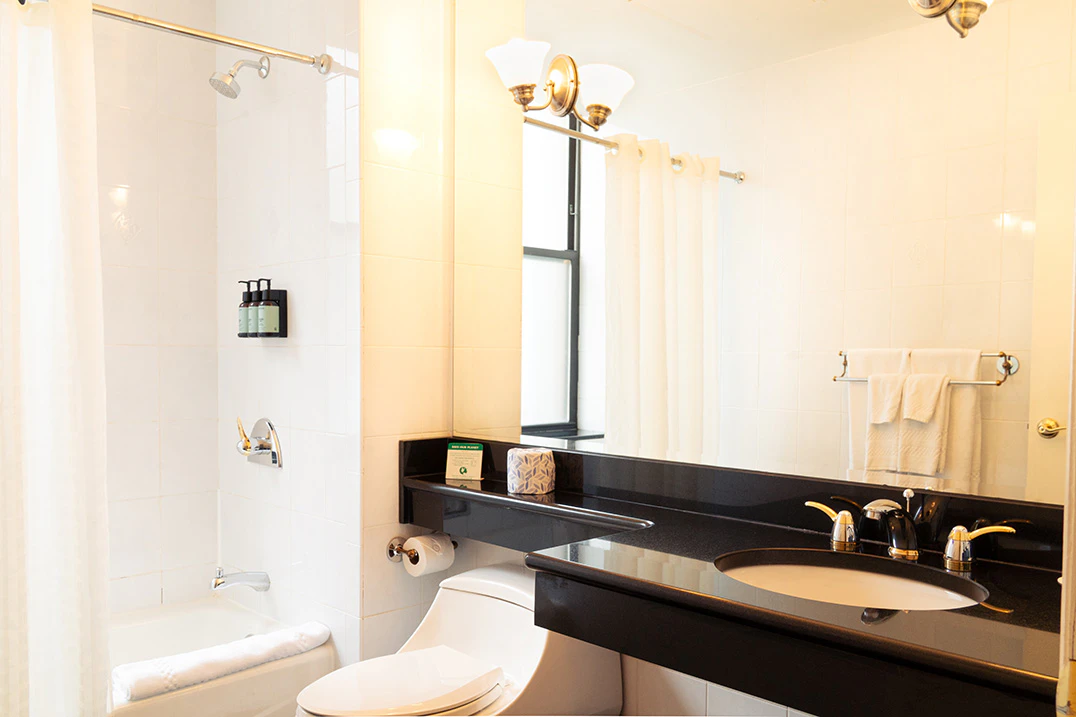 A clean bathroom with a toilet, sink, shower, and bathtub.