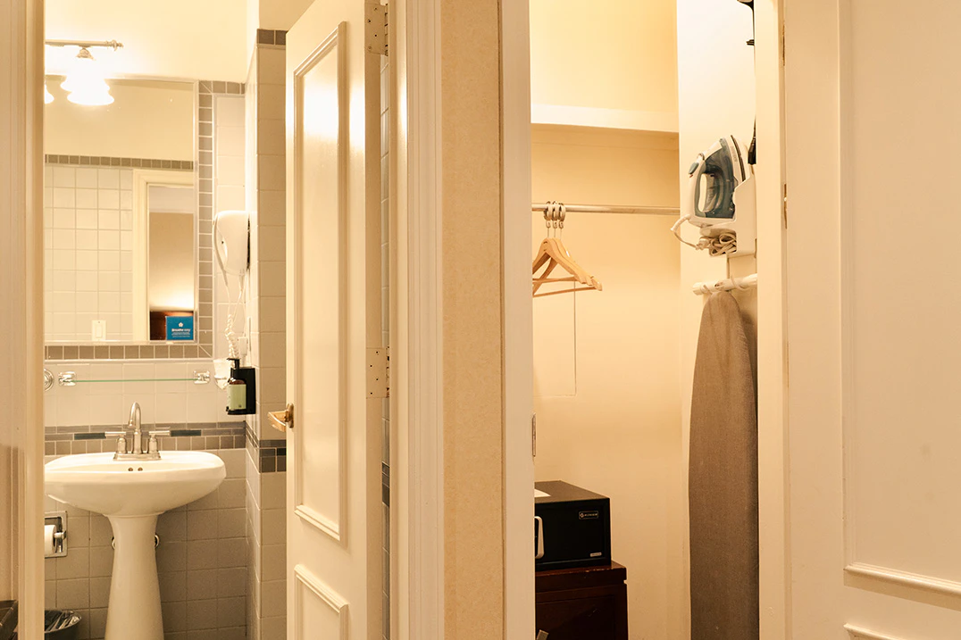a hotel room's bathroom and closet